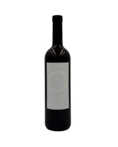 Bottiglia di Giorgio Mercadelli B Bianco Vino Bianco 2012 con un'etichetta bianca minimalista che presenta un cerchio con un punto al centro e la lettera "B" in grigio chiaro, con l'annata "2012" in basso.